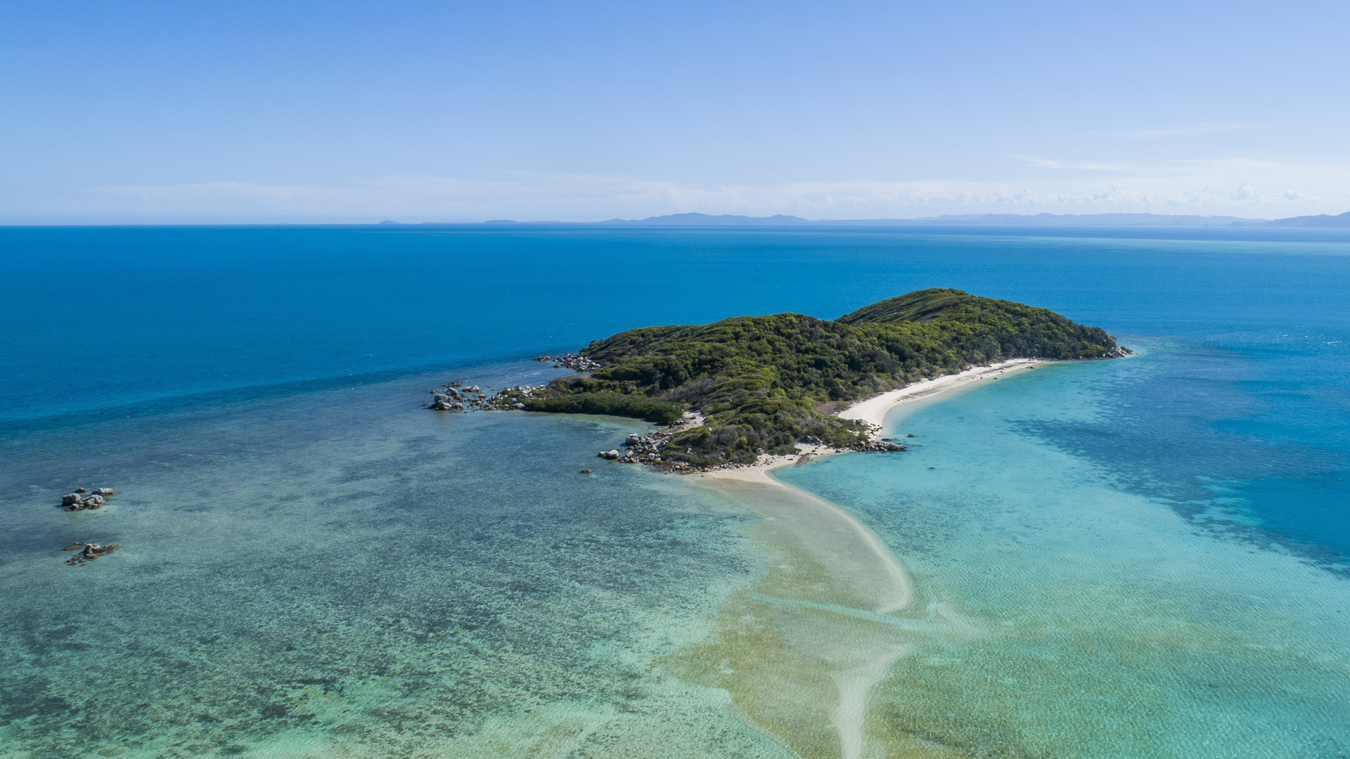 Aerial view of a pristine tropical island, a highlight on the Darwin to Cairns cruise